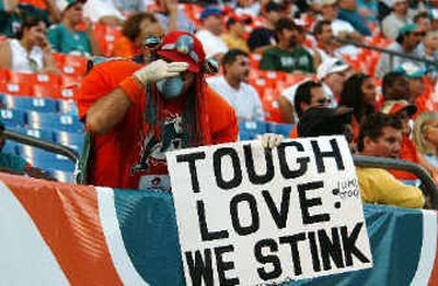 
An unidentified fan holds his nose as the Dolphins allow the Cardinals to score late in the fourth.
 (Associated Press / The Spokesman-Review)