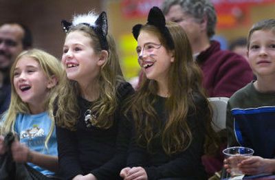 
Wilson Elementary School students Sophie Carter, Madeline Smith and Jade Savage,  left to right, react to a humorous poem written and recited by Spokane children's author Kenn Nesbitt in the South Hill school's gym  Monday evening. Students and parents were invited to wear costumes to the poetry reading, which included some spooky poems. 
 (Holly Pickett / The Spokesman-Review)