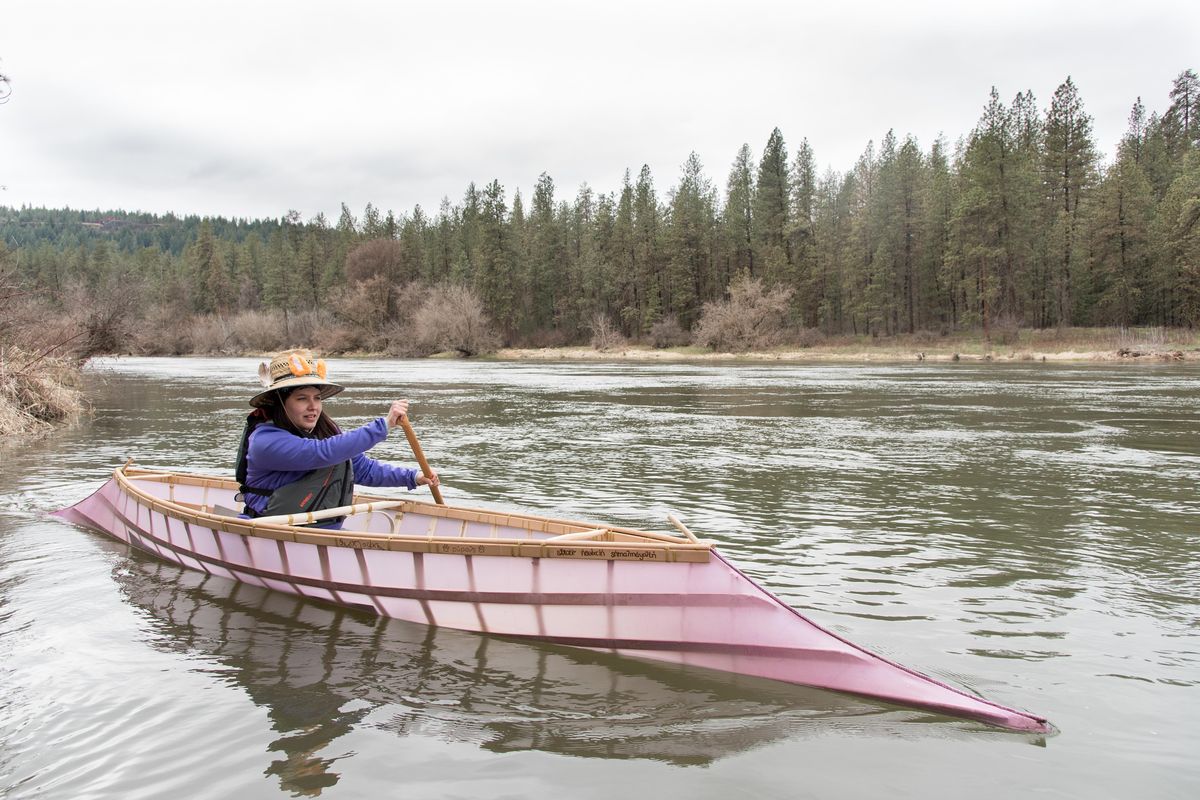 Crystal Conant launches into the Spokane River on April 6 in a traditionally made Salishan Sturgeon Nose Canoe. The canoe is 16 feet long and weighs about 40 pounds. (Eli Francovich / The Spokesman-Review)