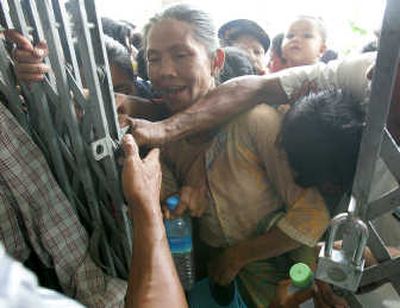
Survivors of Cyclone Nargis rush to get first in line to receive goods from a local donor at a monastery outside the capital of Yangon on Monday. Associated Press
 (Associated Press / The Spokesman-Review)