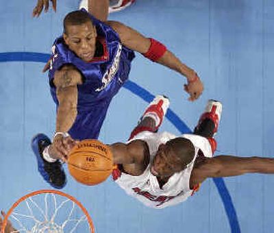 
Rookie Andre Iguodala, left, and sophomore Dwyane Wade battle for a rebound during the NBA Rookie Challenge, won by the sophomores 133-106. 
 (Associated Press / The Spokesman-Review)