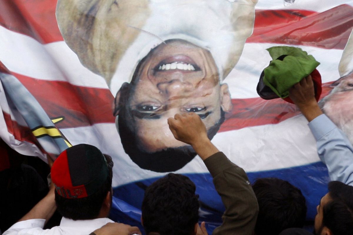 Pakistani protesters hold a banner depicting U.S. President Barack Obama and pastor Terry Jones during a rally in Peshawar, Pakistan as a part of widespread anger across the Muslim world about a film ridiculing Islam