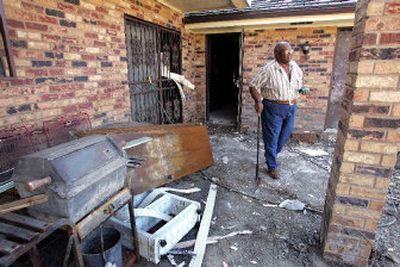 
Charles Larche surveys his damaged home in east New Orleans, La. Contractors have already begun the process of tearing out walls and flooring, but Larche's insurance company says he had no insurance on his home. 
 (Associated Press / The Spokesman-Review)