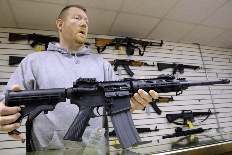 This Jan. 16 file photo shows John Jackson, co-owner of Capitol City Arms Supply, with an AR-15 rifle for sale at his business in Springfield, Ill.  From Oregon to Mississippi, President Barack Obama's proposed ban on new assault weapons and large-capacity magazines struck a nerve among rural lawmen and lawmakers, many of whom vowed to ignore any restrictions and even try to stop federal officials from enforcing gun policy in their jurisdictions. (Seth Perlman / Associated Press)