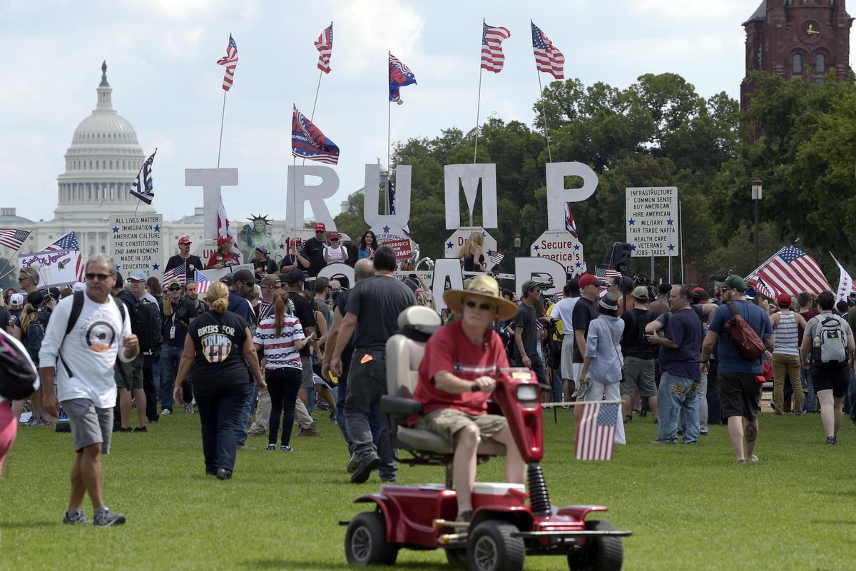 With the U.S. Capitol in the background, people gather on the National Mall in Washington, Saturday, Sept. 16, 2017, to attend a rally in support of President Donald Trump in what organizers are calling 