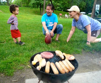During an extended-family summer picnic at their local public park, 2-year-old Yanis enjoys playing football with his grandma, Brenda, and his cousin, Katie. 