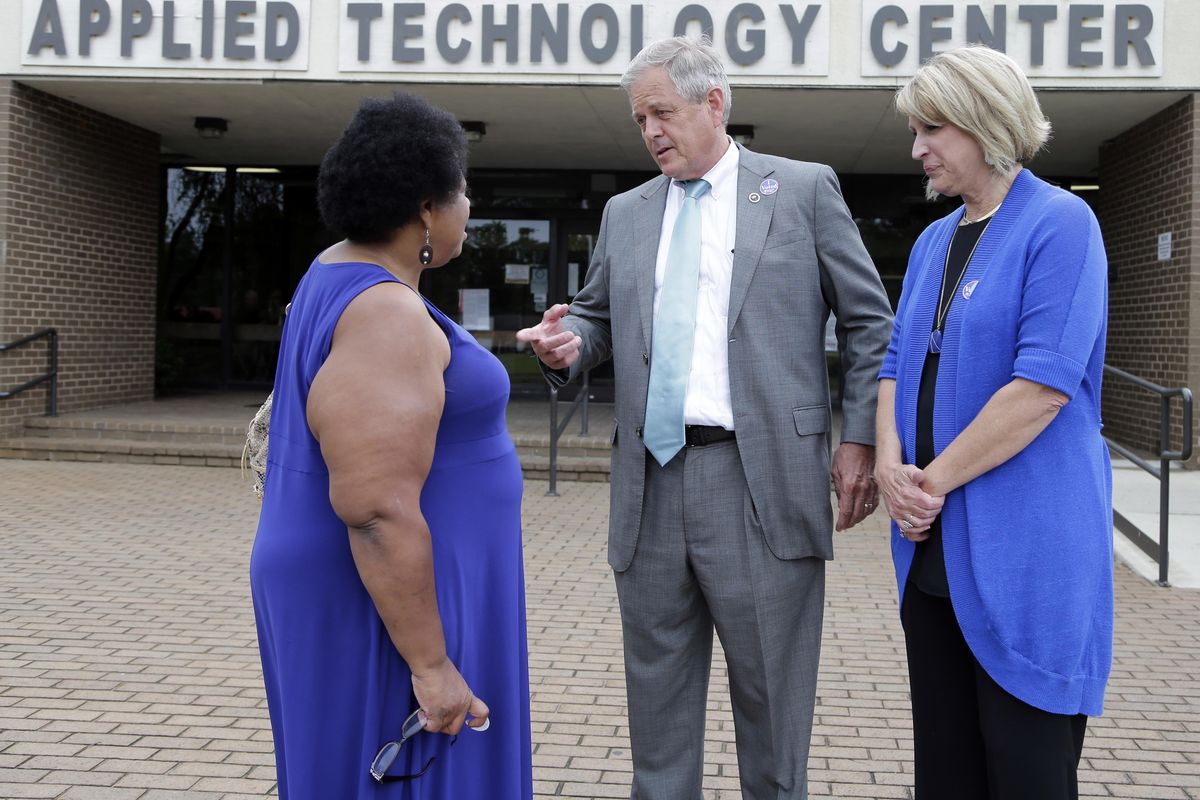 Republican candidate for U.S. Congress Ralph Norman, center, speaks with Gladys Jackson, left, as Norman’s wife, Elaine, right, looks on at a polling place in South Carolina’s 5th Congressional District in Rock Hill, S.C., Tuesday, June 20, 2017. Norman is running against Democrat Archie Parnell. (Chuck Burton / Associated Press)
