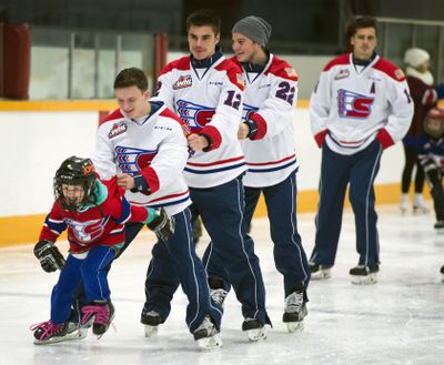 Jordyn Miller, 7, pulls a line of Spokane Chiefs, including Keanu Yamamoto, Markson Bechtold, Dominic Zwerger and a trailing Adam Helewka, during the Skate with the Chiefs on Monday  at the Eagles Ice-A-Rena. Some 200 fans and community members skated with the WHL players for a $5 fee with proceeds benefiting the Vanessa Behan Crisis Nursery. While half of the 24 players skated, the remaining team members signed autographs off the ice. (Dan Pelle / The Spokesman-Review)