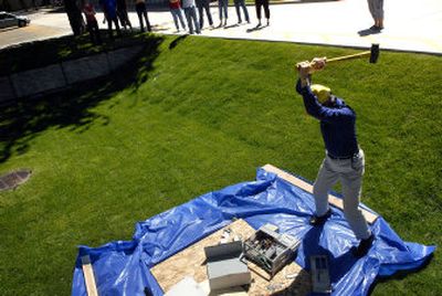 
Richard Chan, technology service manager at Central Premix, smashes a computer on Friday for the Vanessa Behan Crisis Nursery. 
 (Jed Conklin / The Spokesman-Review)