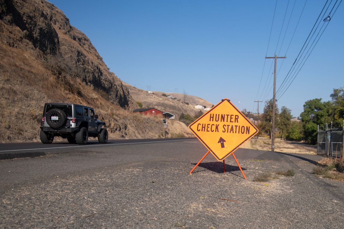A sign directs hunters to a check station on Oct. 13 near Asotin, Wash. A bill moving through the Washington State Legislature poses to raise fees for most hunting and fishing licenses by nearly 40%. If the bill passes, it will not only raise prices for residents and nonresidents but increase the fees and upwork required by the Washington Department of Fish and Wildlife. (MICHAEL WRIGHT/THE SPOKESMAN-REVIEW)