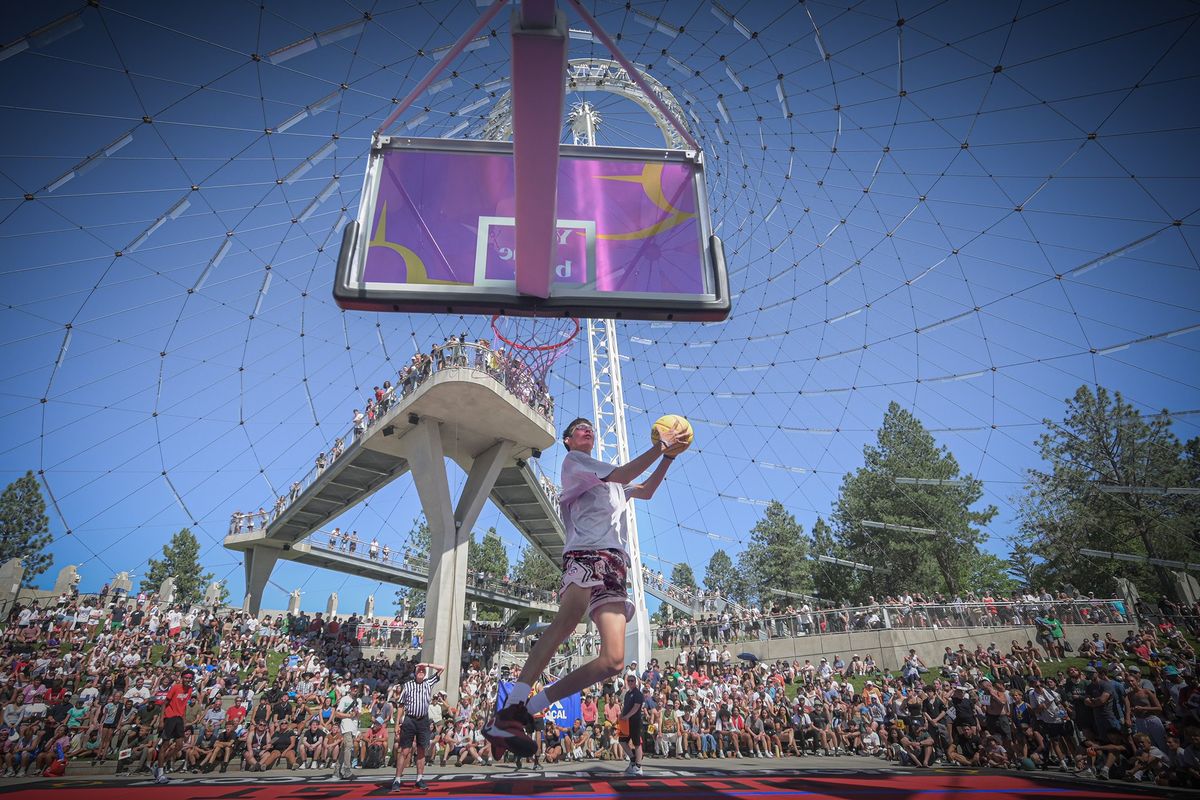 Isaac Fisher, of Kalispell, whips down a windmill dunk Sunday at Hoopfest in downtown Spokane.  (Brian Plonka/For The Spokesman-Review)