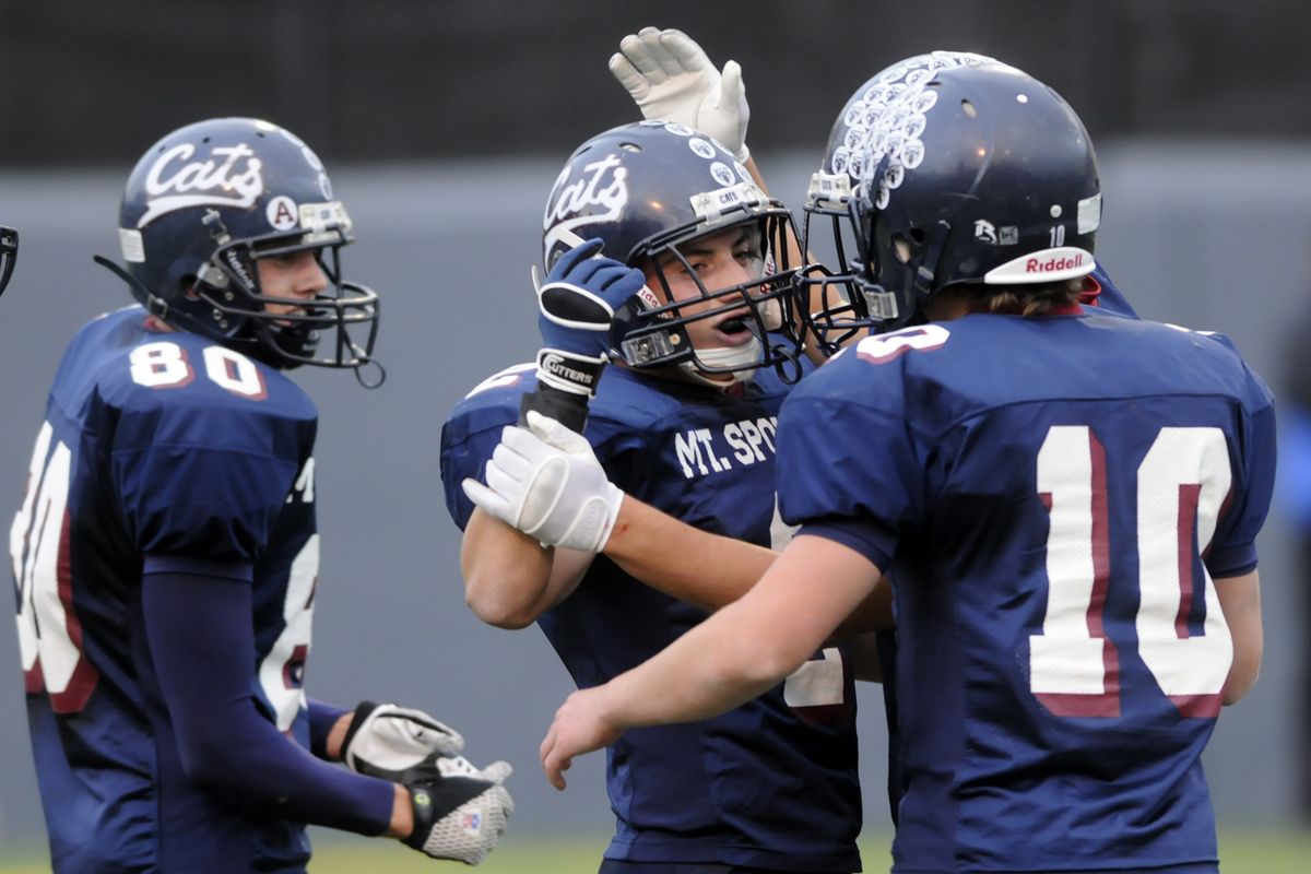 Mt. Spokane’s Chip Propp, Nathan Blackham and quarterback Travis Ward, left to right, celebrate a score.jesset@spokesman.com (Jesse Tinsley / The Spokesman-Review)