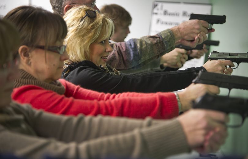 Students learn to handle handguns during a gun safety class at Sharp Shooting Indoor Range and Gun Shop in Spokane. (Colin Mulvany)
