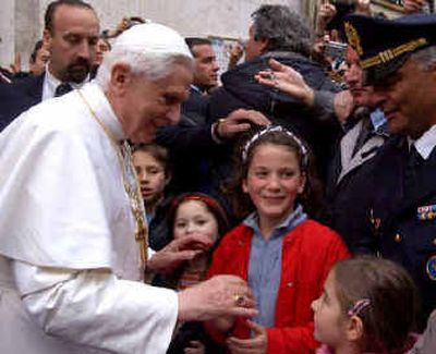 
Pope Benedict XVI greets children and the crowd gathered in front of his former private home in Rome on Wednesday. 
 (Associated Press / The Spokesman-Review)
