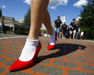 ORG XMIT: ORROS101 In this April 24, 2009 photo, men wearing high heel shoes take part in the Walk-A-Mile in Her Shoes event in downtown Roseburg, Ore. About 100 men took part in the one mile walk to raise awareness about sexual violence and rape. (AP Photo/The News-Review, Robin Loznak) (Robin Loznak / The Spokesman-Review)