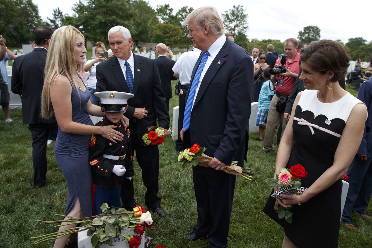 Brittany Jacobs, left, and 8-year-old son Christian Jacobs meet President Donald Trump and Vice President Mike Pence in Section 60 of Arlington National Cemetery, Monday, May 29, 2017, in Arlington, Va. Christian Jacobs’ father, Marine Sgt. Christopher Jacobs, was killed in 2011. (Evan Vucci / Associated Press)