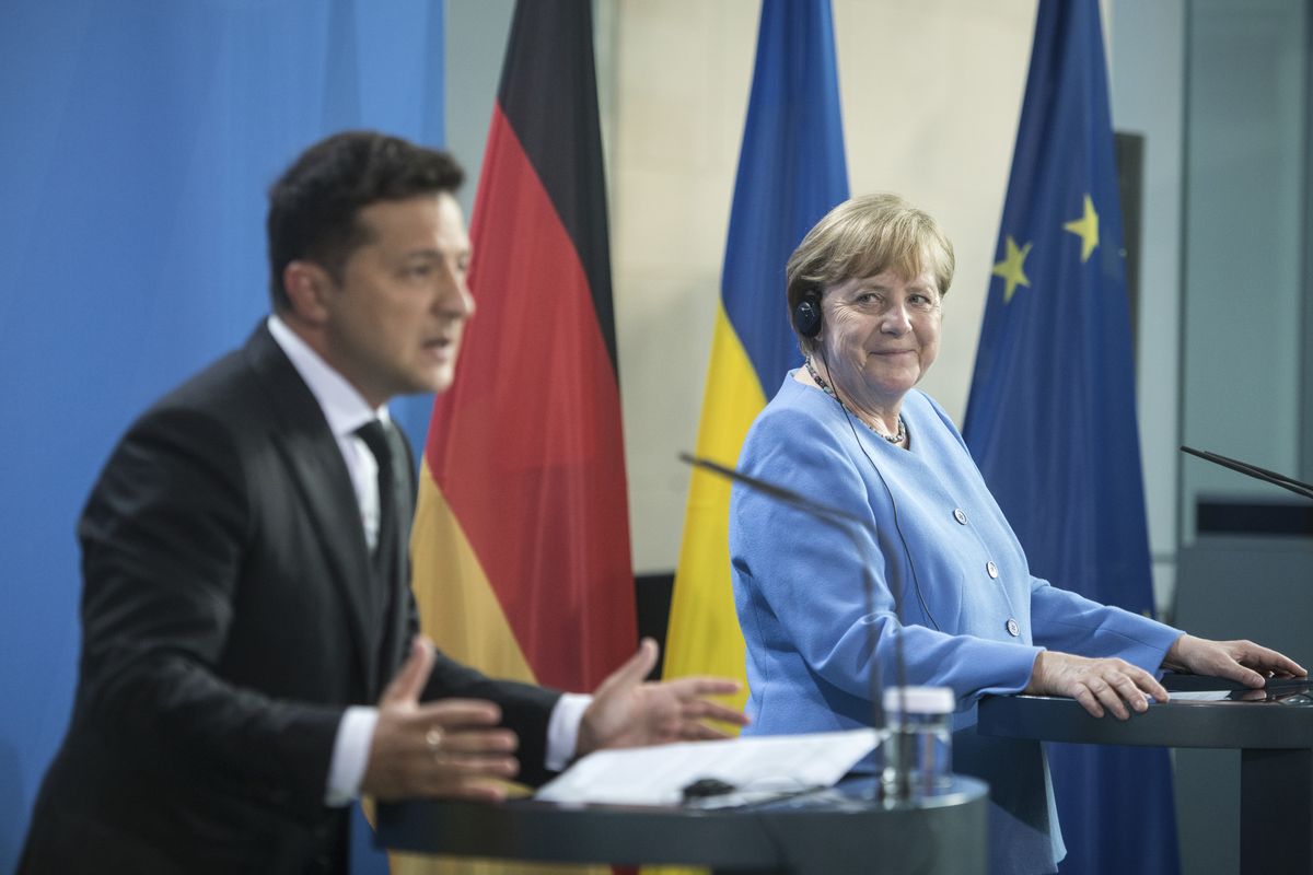 German Chancellor Angela Merkel, right, and Ukrainian President Volodymyr Zelensky give statements ahead of talks at the Chancellery in Berlin, Monday, July 12, 2021.  (Stefanie Loos)