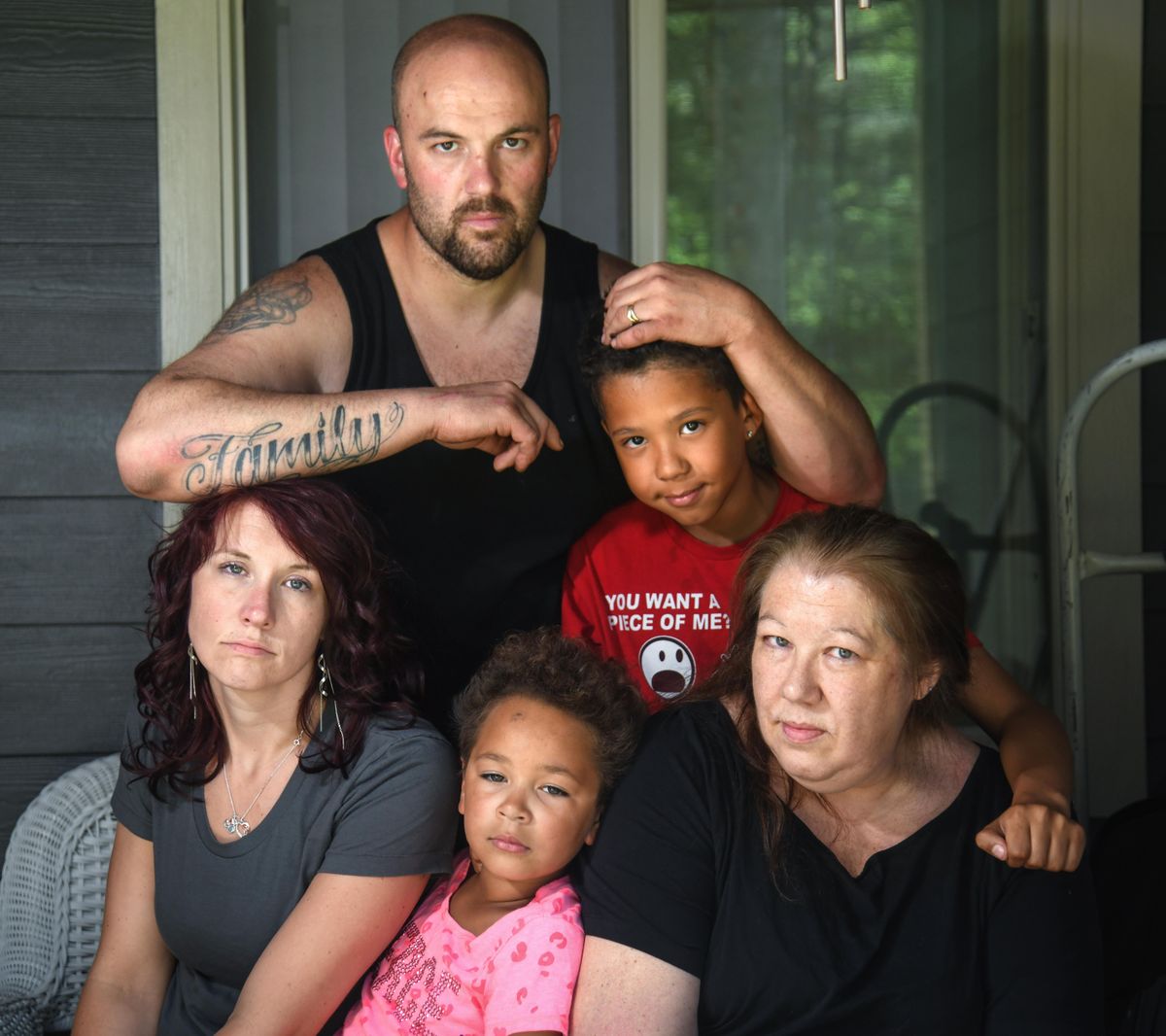 Sharona Carroll, 39, died in the Spokane County Jail on June 11, 2019. Clockwise from top, her brother Jason Carroll, son Angelo Miller, mother Jana Akins, daughter Aaliya Camps and sister Brittani Bennett pose for a family photo on June 14, 2019. (Dan Pelle / The Spokesman-Review)