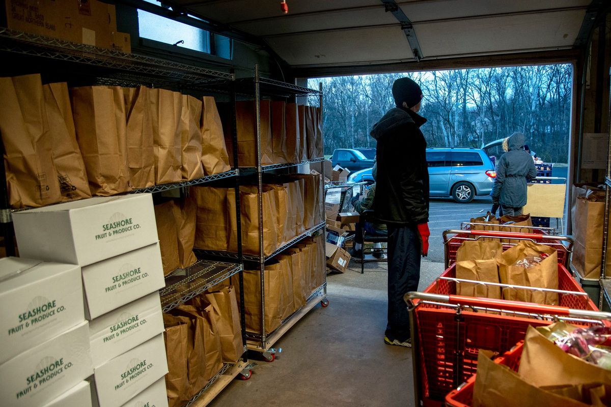 Volunteers distribute food items at the drive-through Martha