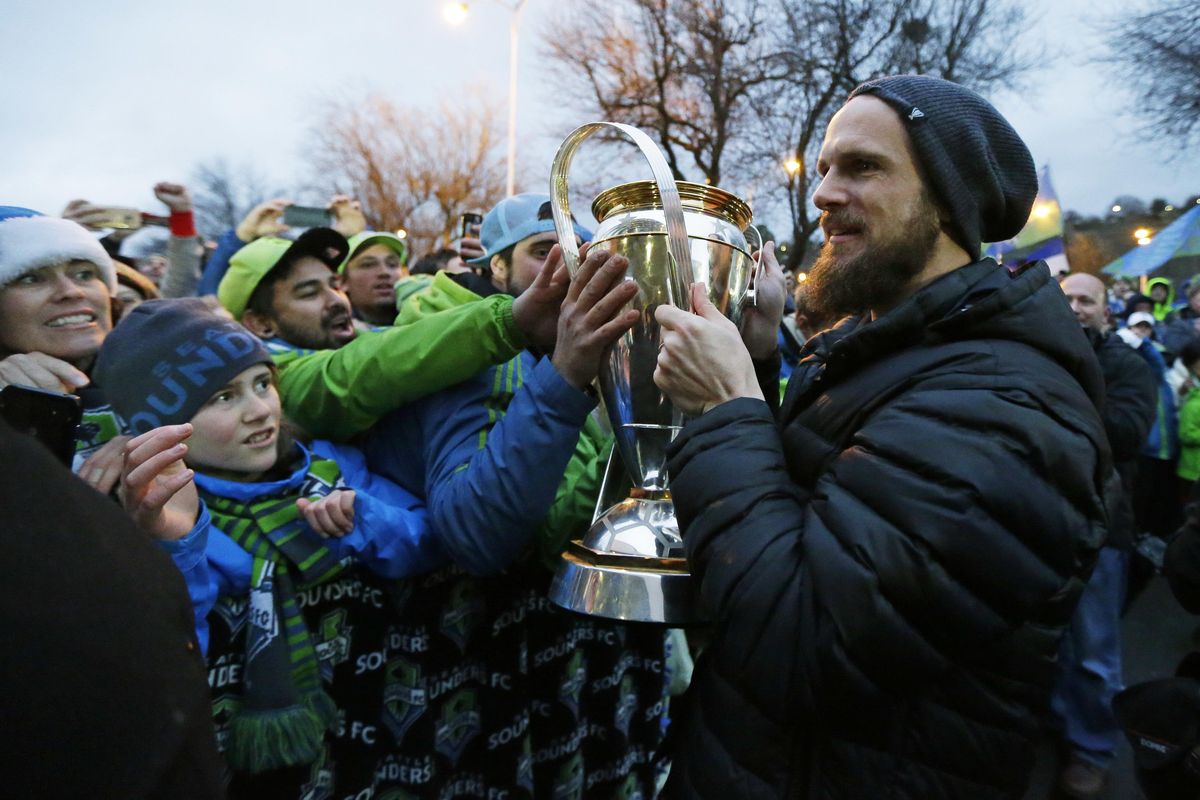 Seattle Sounders goalkeeper Stefan Frei holds the MLS Cup as he greets supporters at a fan rally at the King County Airport in Seattle on Sunday, Dec. 11, 2016. Frei was the soccer match MVP as the Sounders defeated Toronto FC Saturday in Toronto to win the cup. (Ted S. Warren / Associated Press)