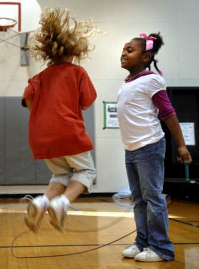 
Second-graders Zaraih Whitsett, right, and Emma Clayton jump doubles during jump-rope club at Broadway Elementary.
 (Holly Pickett / The Spokesman-Review)