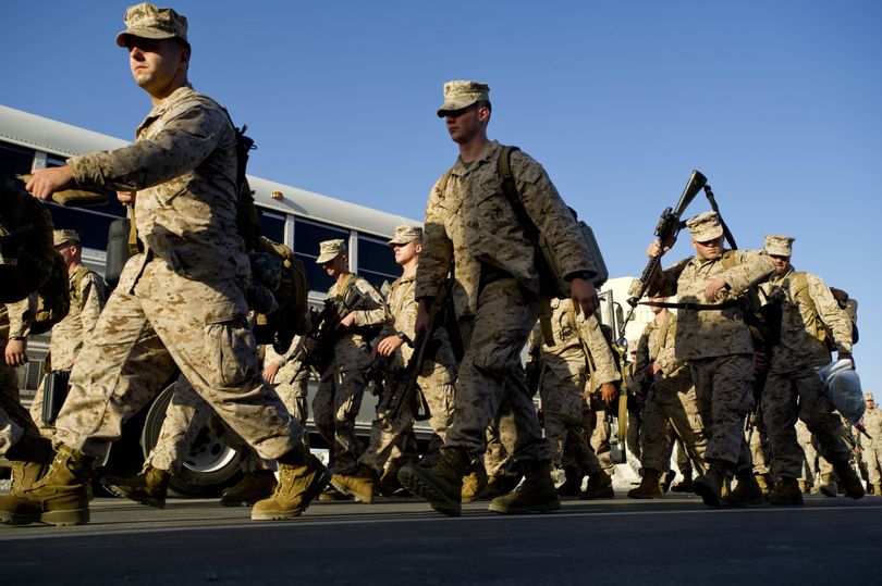 At the Manas Transit Center, Marines with the 2nd Battalion, 1st Marines, make preparations for haeding downrange in to Afghanistan Sunday, Oct. 17, 2010. (Colin Mulvany / The Spokesman-Review)