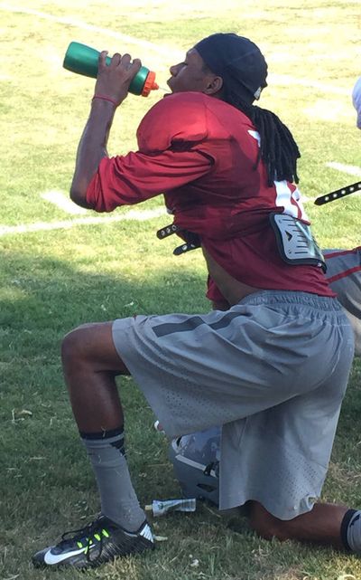 Washington State freshman receiver Tavares Martin Jr. tries to keep cool in the Lewiston heat on Tuesday. With the temperatures in triple digits, the WSU players are tested daily for dehydration. (Jacob Thorpe)