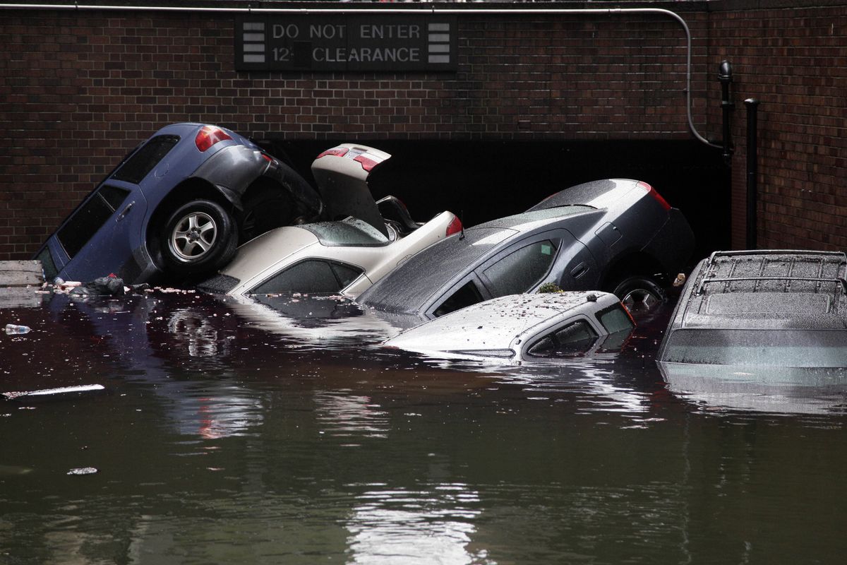 Cars are submerged at the entrance to a parking garage in New York