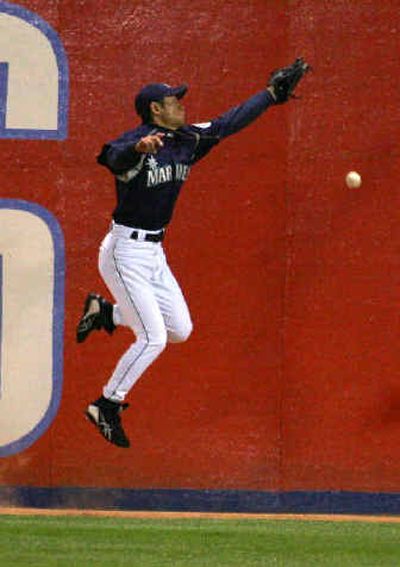 
Seattle's Ichiro Suzuki misses a fly ball in the fourth inning against the Cubs.
 (Associated Press / The Spokesman-Review)