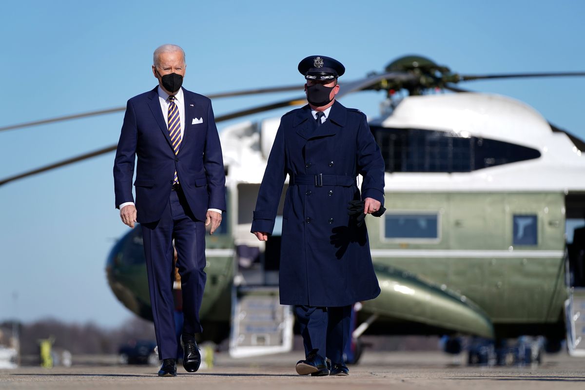 President Joe Biden, escorted by Colonel Matthew Jones, Commander, 89th Airlift Wing, walks to board Air Force One, Tuesday, Jan. 11, 2022, at Andrews Air Force Base, Md. Biden is en route to Atlanta.  (Patrick Semansky)