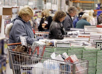 
Shoppers look over books for sale at the Costco warehouse store in Colchester, Vt., in early December. Costco posted a 7 percent gain in same-store sales, beating the 6 percent estimate from analysts. 
 (Associated Press / The Spokesman-Review)