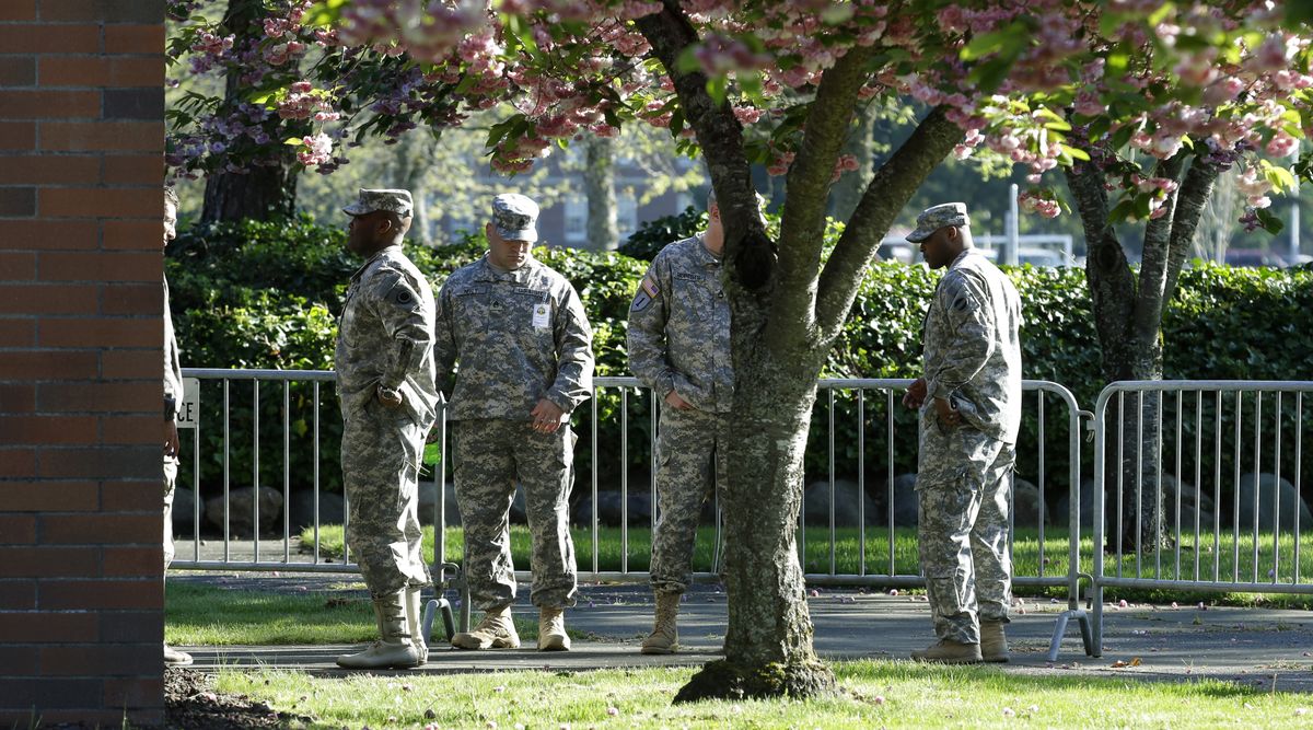 Soldiers assist with communications and security tasks at Joint Base Lewis-McChord, Wash., on Monday during the court-martial for U.S. Army Sgt. John Russell. (Associated Press)