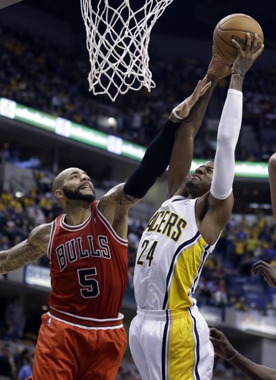 Indiana’s Paul George is fouled by Chicago’s Carlos Boozer. (Associated Press)