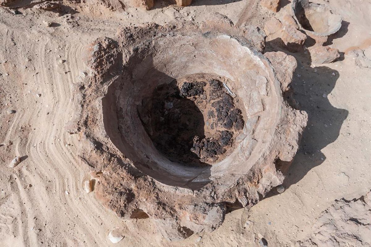 This photo provided by the Egyptian Antiquities Ministry on Saturday, Feb. 13, 2021 show a pottery basin, which archaeologists say had been used to heat up a mixture of grains and water to produce beer, in Abydos, some 450 km (280 miles) south of Cairo, Egypt. The basins were part of what could be the oldest known beer factory unearthed in Abydos, an ancient burial ground dating back to the region of King Narmer, the last king of the Predynastic Period (6000 - 3150 B.C.), according to Mostafa Waziri, secretary general of the Supreme Council of Antiquities.  (HOGP)