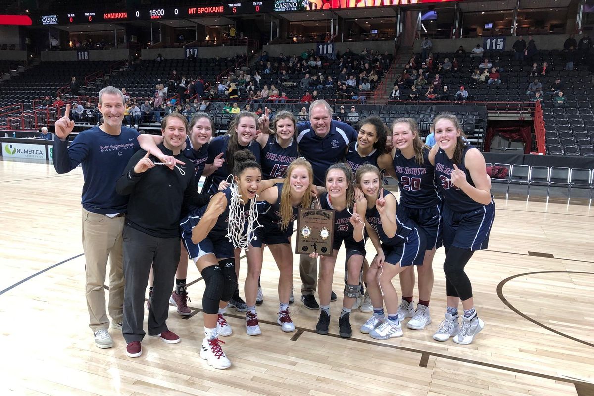 Mt. Spokane poses with the District 8 3A girls championship plaque after knocking off Kamiakin 46-45 at the Spokane Arena on Feb. 16, 2019. (Dave Nichols / The Spokesman-Review)