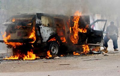 
A British military SUV burns after being hit by a rocket-propelled grenade in Basra, Iraq,  on Monday. One soldier was wounded. 
 (Associated Press / The Spokesman-Review)