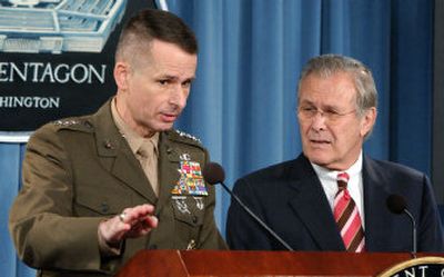 
Defense Secretary Donald Rumsfeld looks on as Chairman of the Joint Chiefs of Staff Gen. Peter Pace answers a reporter's question during a news conference at the Pentagton on Tuesday. 
 (Associated Press / The Spokesman-Review)