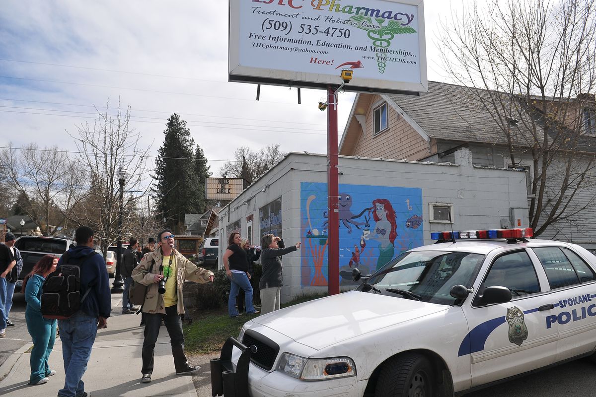 Marijuana activists chant in protest outside the THC Pharmacy pot dispensary on Perry Street on Thursday. The DEA raided the dispensary while most dispensary owners and pot activists were at a meeting about how to handle DEA raids. (Jesse Tinsley)