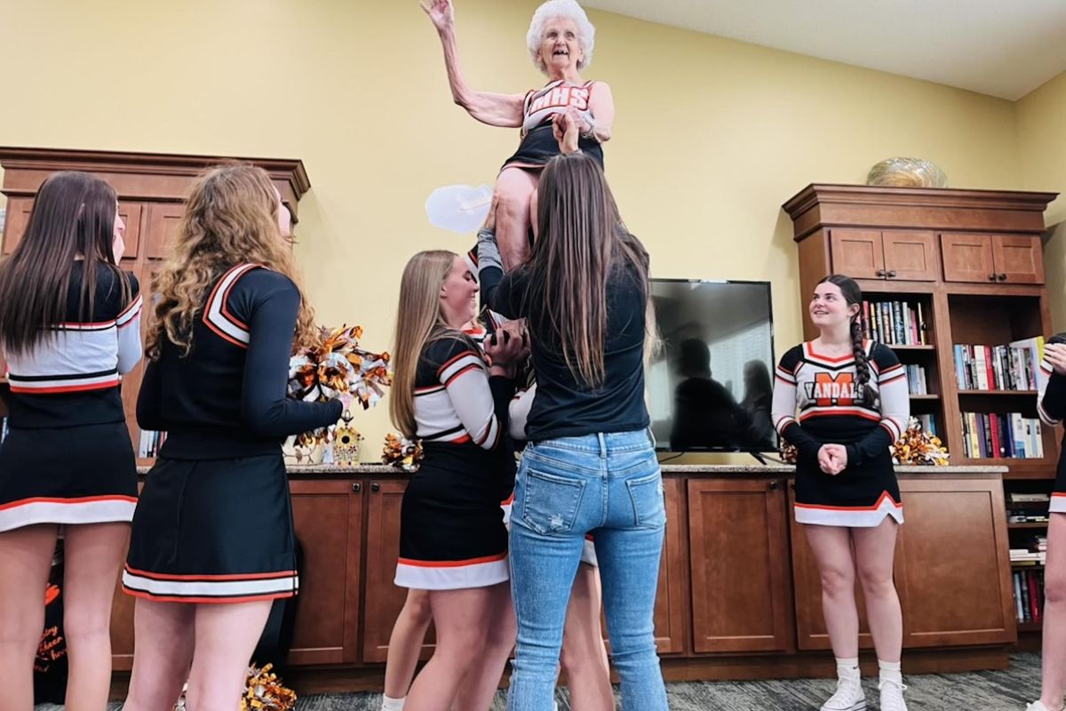 Ilagene Doehring, 97, performs a stunt with the Merrill High School cheerleading squad.  (Courtesy of Arielle Radick)