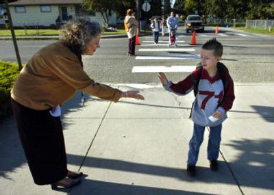 
Trentwood Elementary School Principal Sigrid Brannan welcomes first-grader Jabriel Anderson to the first day of class in the East Valley School District after he crossed a busy Wellesley Avenue on Wednesday. 
 (Dan Pelle / The Spokesman-Review)