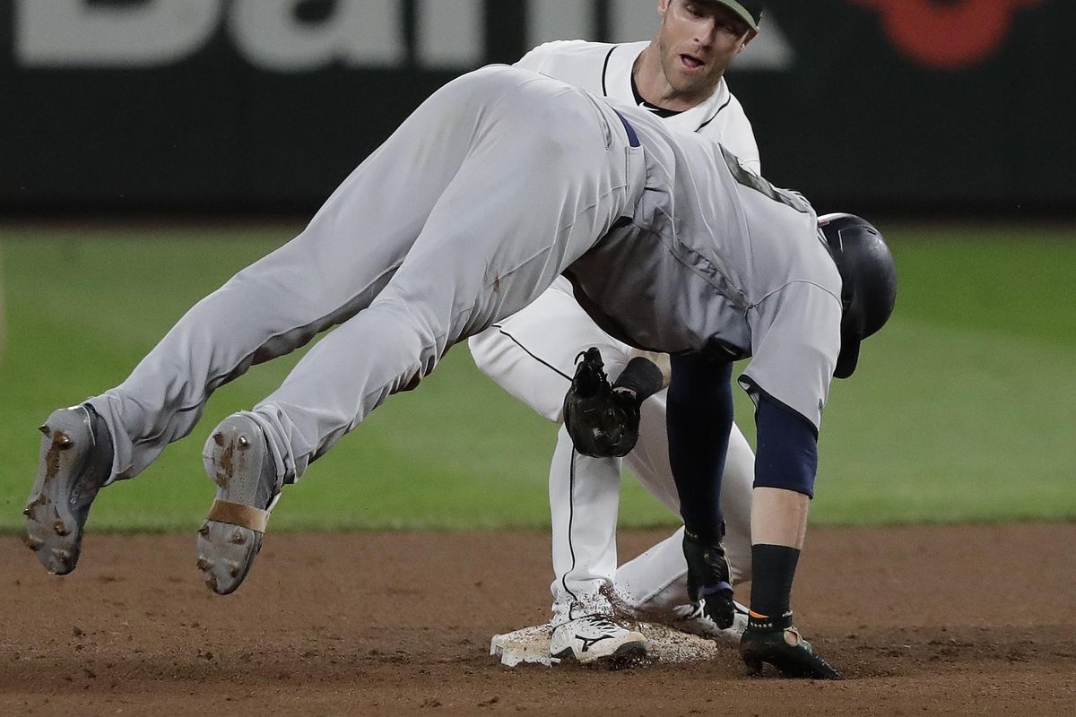 Minnesota’s Logan Morrison is tagged out by Seattle Mariners shortstop Andrew Romine at second base after Morrison tried to stretch a single into a double during the ninth inning  Saturday in Seattle. (Ted S. Warren / AP)