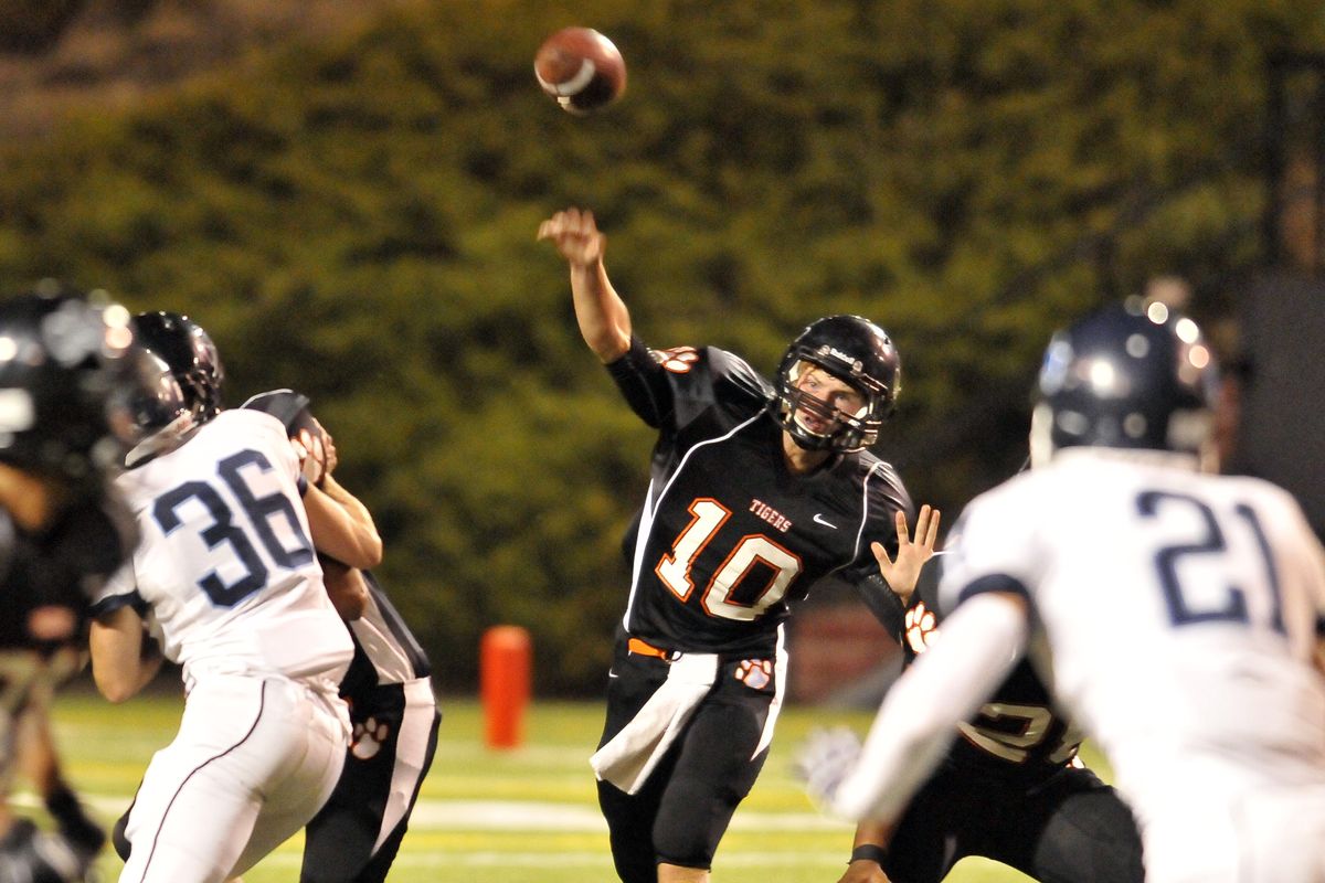 Lewis and Clark Tigers quarterback Andrew Black lets it fly under pressure from the Gonzaga Prep Bullpups defense during the first quarter on Friday night. (Jesse Tinsley)