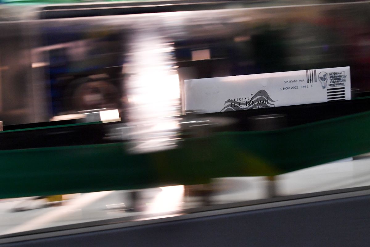 A ballot is a blur as it makes its way through a mail sorting machine on Tuesday, Nov 2, 2021, at the Spokane County Elections Office in Spokane, Wash.  (Tyler Tjomsland/The Spokesman-Review)