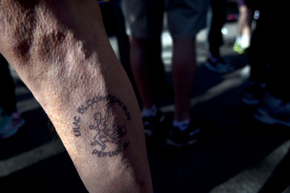 Bloomsday Perennial Steve Moe shows off his tattoo Sunday before the start of the  Bloomsday Perennials Run in Spokane. (Kathy Plonka / The Spokesman-Review)