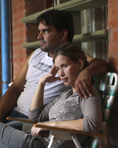 Analia Bouter and her husband Fabian Veron sit outside the hospital in Resistencia, Argentina on Wednesday. (Associated Press)