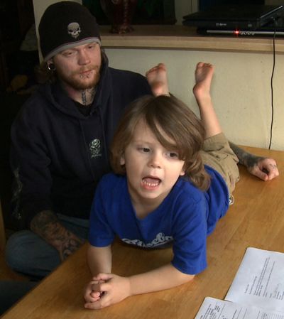 In this Dec. 16, 2009 image made from video, four-year-old Taylor Pugh is seen in Balch Springs, Texas. The parents of Pugh, a pre-kindergarten student nicknamed Tater Tot, are battling a suburban Dallas school's decision to segregate their son because his long locks violate the district dress code. At left is Taylor's father Delton Pugh. (Rich Matthews / Associated Press)