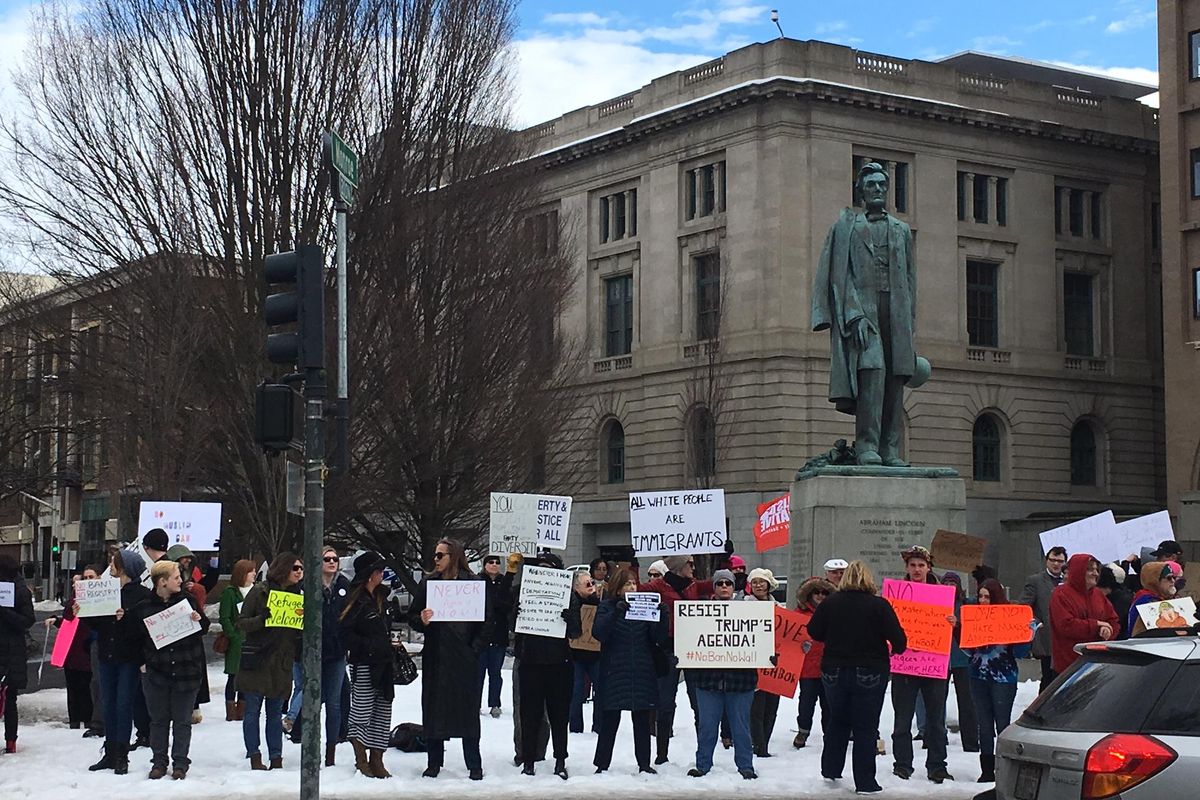 Protesters gather in downtown Spokane on Sunday afternoon against President Donald Trump’s order targeting people from many Muslim nations. (Jesse Tinsley / The Spokesman-Review)