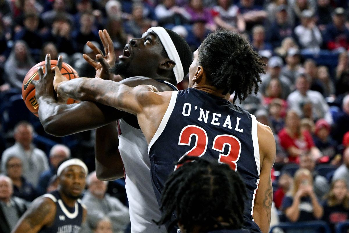 Gonzaga forward Graham Ike (13) is fouled by Jackson State forward Jordan O'Neal (23) as he tries for a layup during the first half of a NCAA college basketball game, Wednesday, Dec. 20, 2023, in the McCarthey Athletic Center.  (COLIN MULVANY)