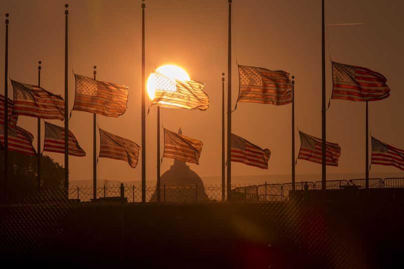 The American flags surrounding the Washington Monument fly at half-staff as ordered by President Barack Obama following the deadly shooting Monday at the Washington Navy Yard, Tuesday morning, Sept. 17, 2013, in Washington. (J. Applewhite / Associated Press)