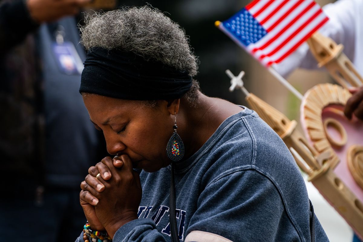 A woman pauses on July 6, 2022, at a memorial near the scene of the July 4 mass shooting in Highland Park, Ill. MUST CREDIT: Washington Post photo by Demetrius Freeman.  (Demetrius Freeman/The Washington Post)